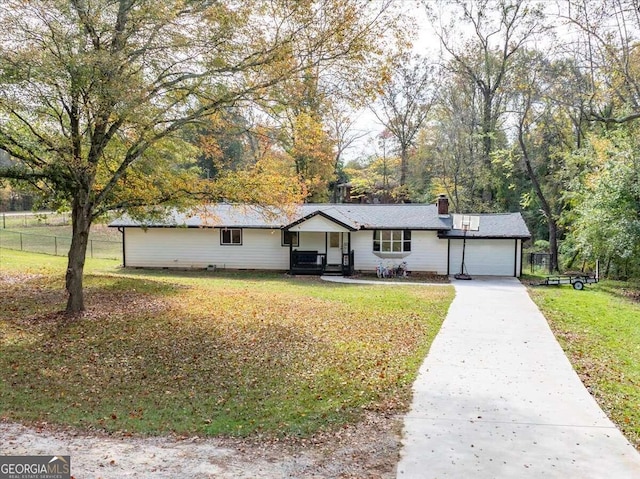 ranch-style house featuring a front lawn and a garage