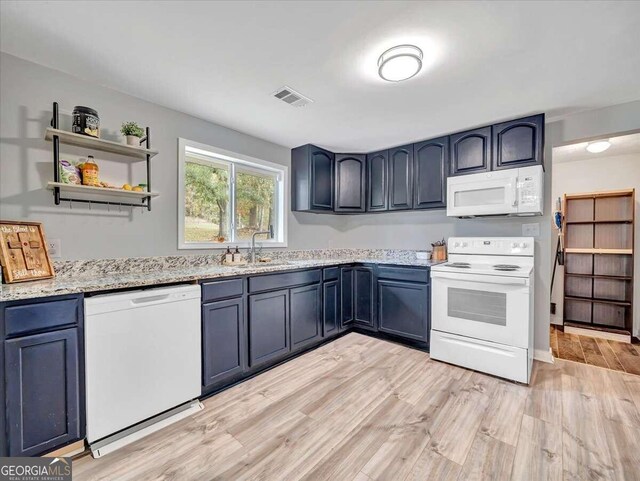 kitchen featuring blue cabinetry, light hardwood / wood-style flooring, sink, and white appliances