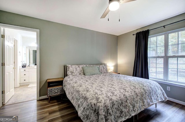 bedroom with dark hardwood / wood-style flooring, connected bathroom, and ceiling fan