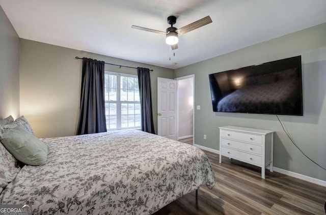 bedroom with ceiling fan and dark hardwood / wood-style flooring