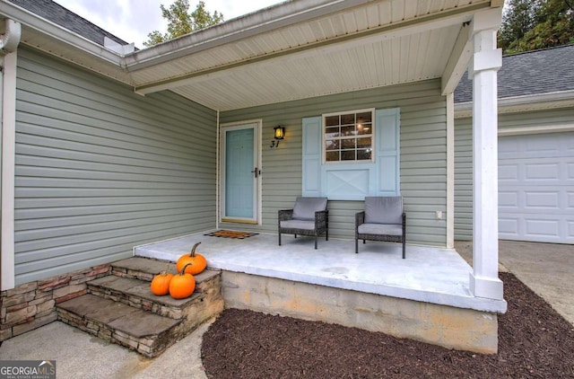 entrance to property featuring a porch and a garage