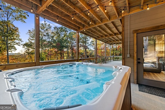 view of swimming pool featuring a hot tub