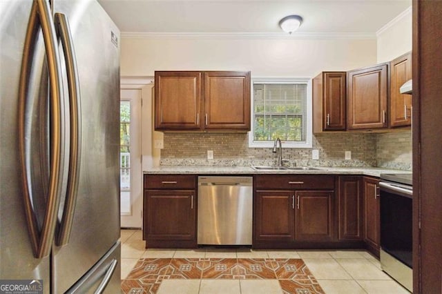 kitchen with sink, appliances with stainless steel finishes, light tile patterned floors, and plenty of natural light