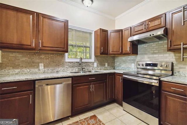 kitchen with light tile patterned floors, stainless steel appliances, decorative backsplash, and sink