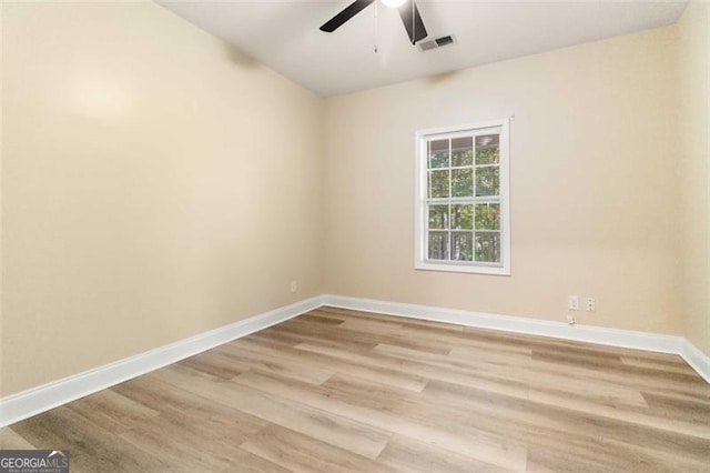 spare room with light hardwood / wood-style flooring and ceiling fan