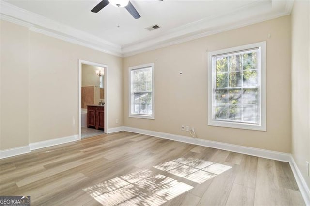 empty room with light hardwood / wood-style flooring, ceiling fan, and crown molding