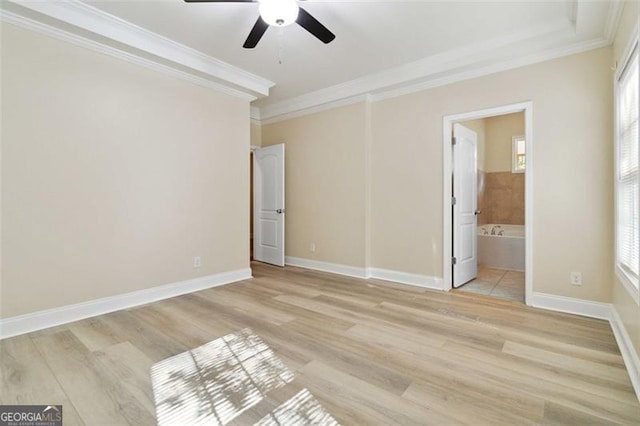 unfurnished bedroom with connected bathroom, light hardwood / wood-style floors, multiple windows, and ceiling fan