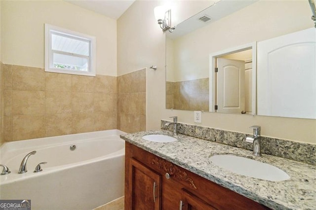 bathroom with vanity and a bathtub