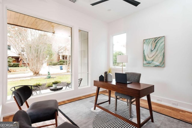 home office featuring plenty of natural light, ceiling fan, and light hardwood / wood-style flooring