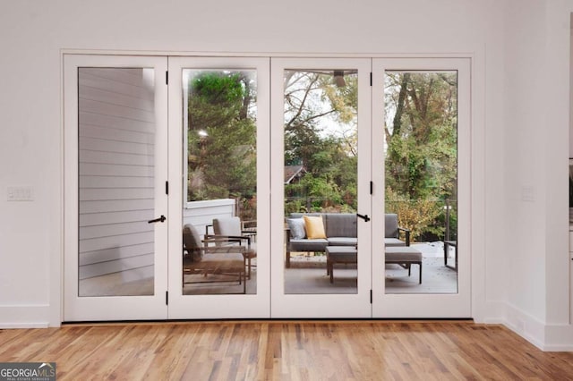 doorway to outside with french doors and light hardwood / wood-style floors