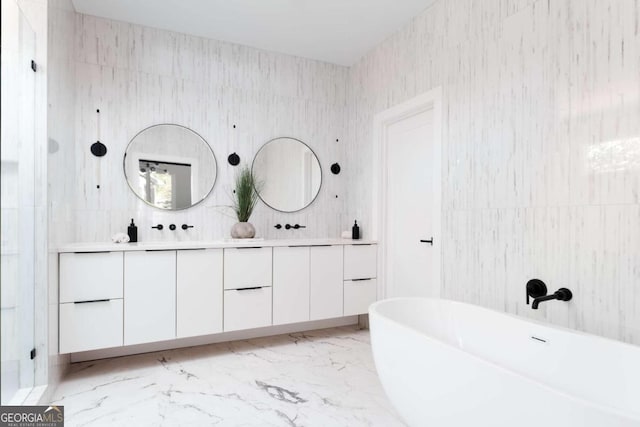 bathroom with tile walls, a bathtub, and vanity