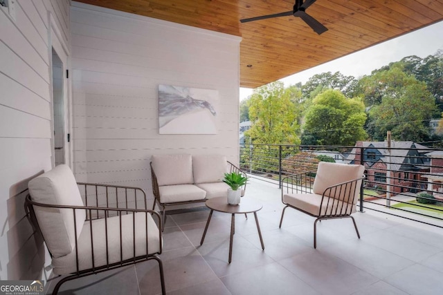 view of patio / terrace with ceiling fan and a balcony