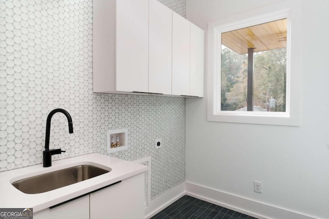 laundry area featuring electric dryer hookup, cabinets, tile patterned flooring, sink, and washer hookup