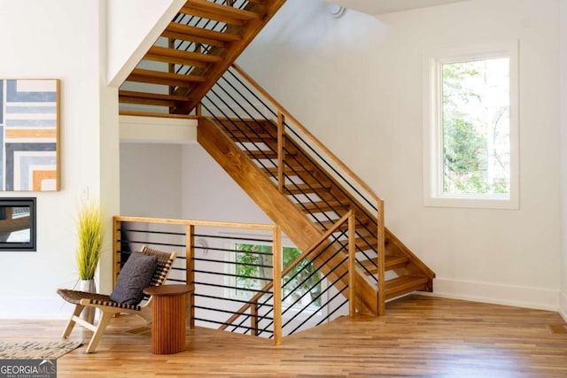 stairway featuring wood-type flooring