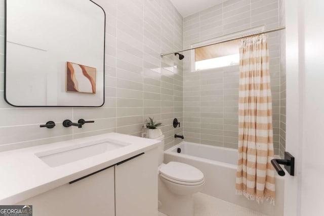 full bathroom featuring shower / tub combo, tile walls, vanity, toilet, and decorative backsplash