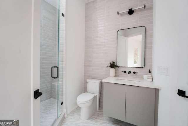 bathroom featuring tile walls, walk in shower, vanity, tile patterned flooring, and toilet