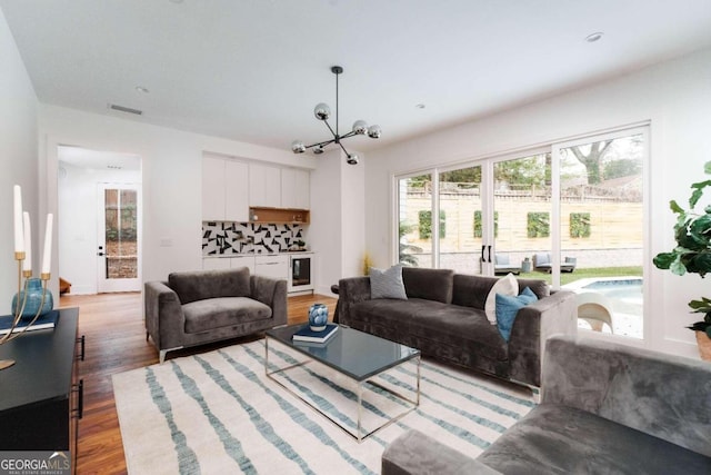 living room featuring hardwood / wood-style flooring and a notable chandelier