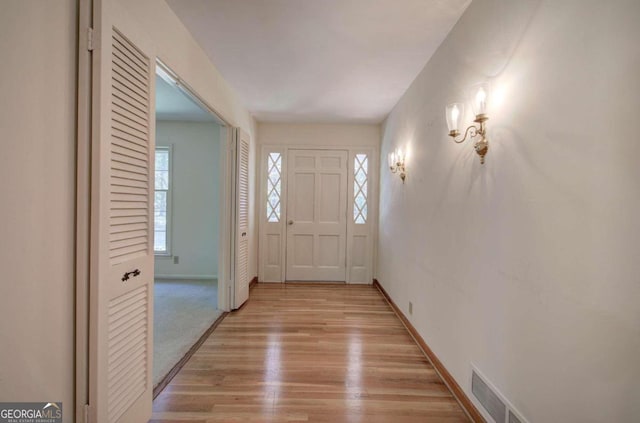 entryway with light wood-style floors, visible vents, and baseboards