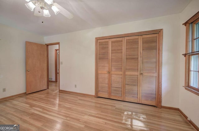 unfurnished bedroom with ceiling fan, a closet, baseboards, and wood finished floors