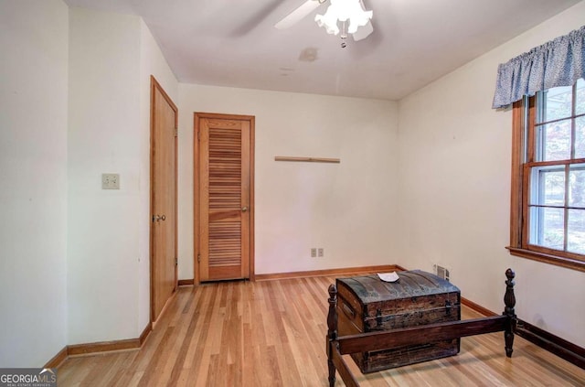 interior space with light wood-type flooring, ceiling fan, and baseboards