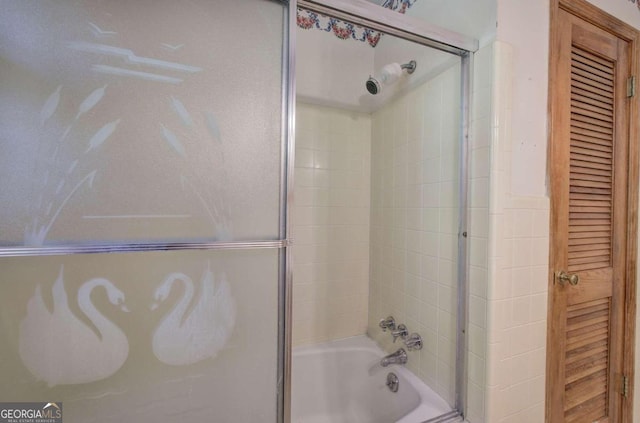 bathroom featuring combined bath / shower with glass door