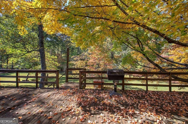 wooden deck featuring a forest view