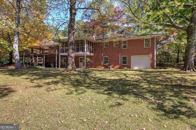 back of house with a lawn, a sunroom, an attached garage, stairs, and brick siding