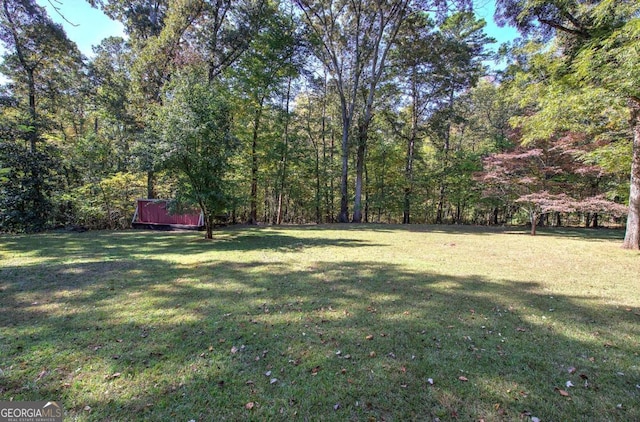 view of yard with a view of trees