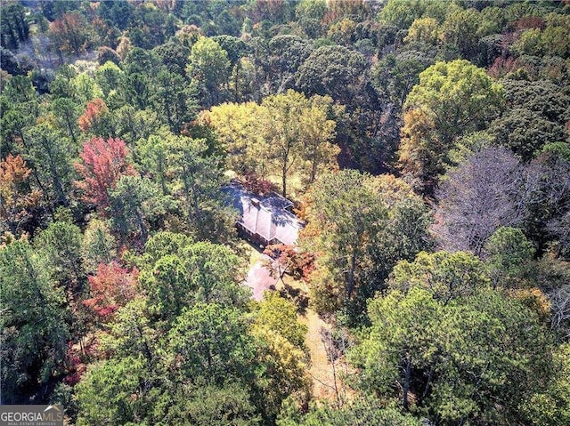 bird's eye view featuring a wooded view