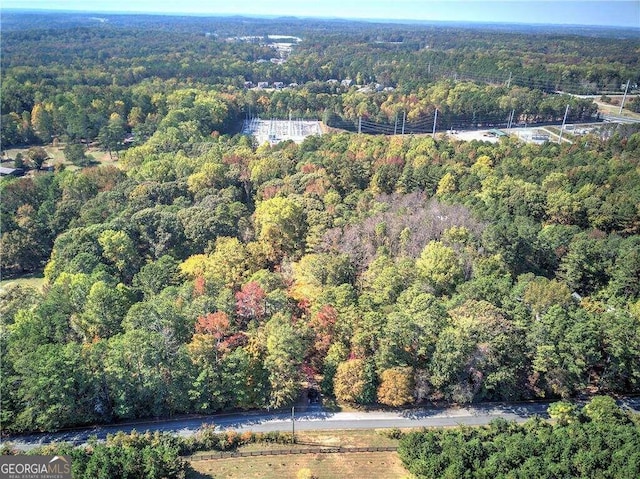 drone / aerial view with a wooded view