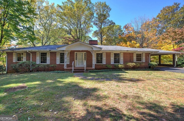 single story home featuring a carport, brick siding, a chimney, and a front lawn