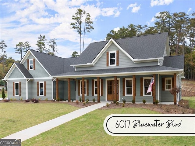 view of front of house with a front yard and covered porch