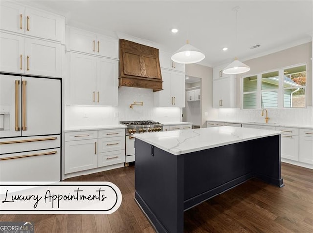 kitchen featuring a kitchen island, custom range hood, premium appliances, white cabinetry, and dark hardwood / wood-style flooring