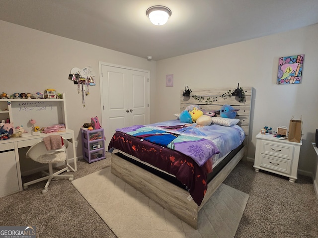 bedroom with dark colored carpet and a closet