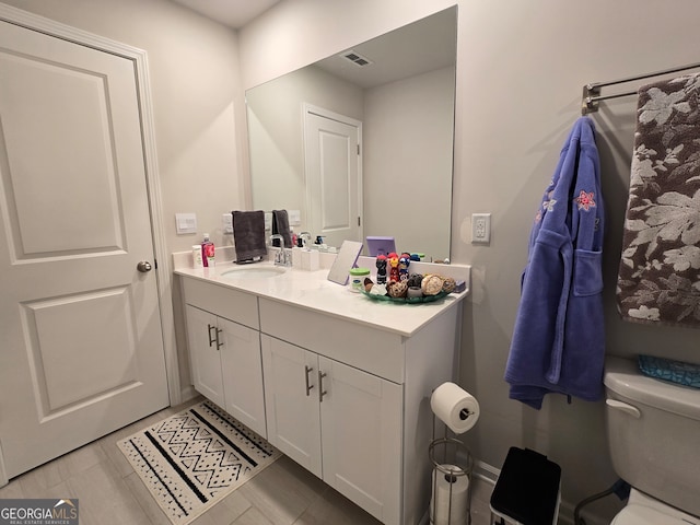 bathroom with toilet and vanity