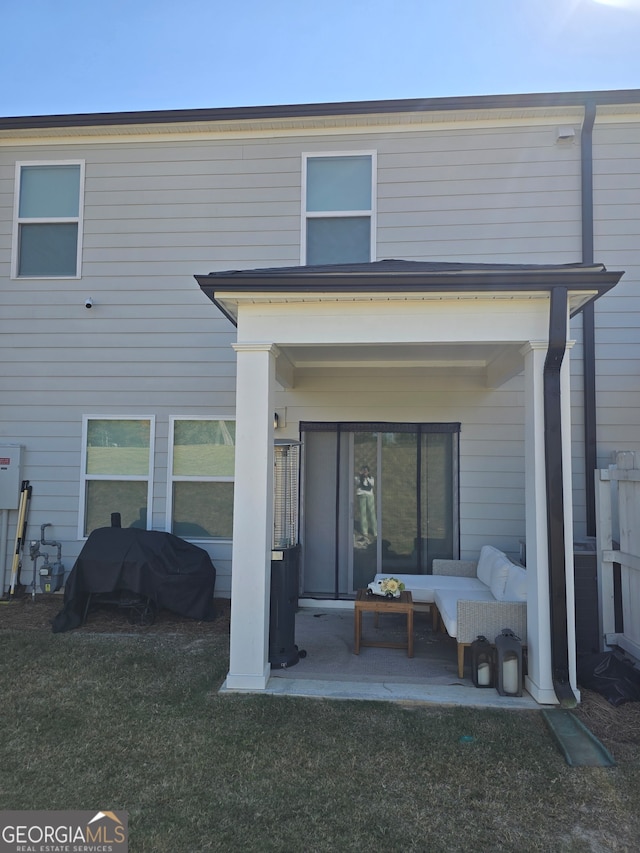 rear view of house with a lawn, an outdoor hangout area, and a patio area