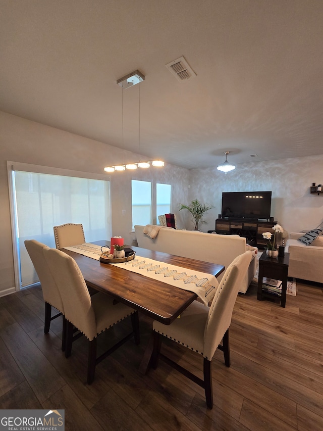 dining space featuring dark hardwood / wood-style flooring