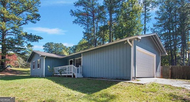 view of side of home with a yard and a garage