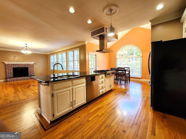 kitchen featuring a wealth of natural light, light hardwood / wood-style floors, sink, and appliances with stainless steel finishes