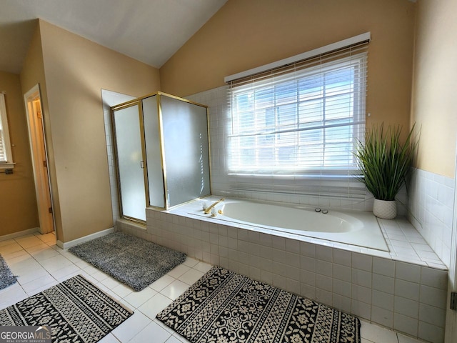 bathroom featuring tile patterned floors, shower with separate bathtub, and vaulted ceiling