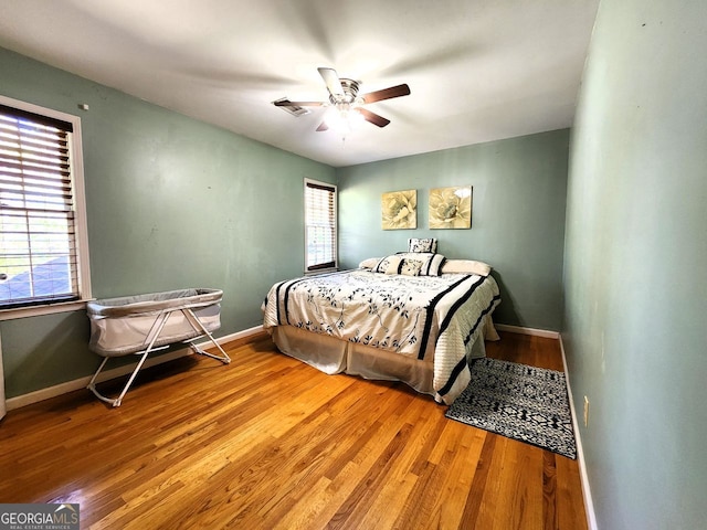 bedroom featuring hardwood / wood-style flooring and ceiling fan