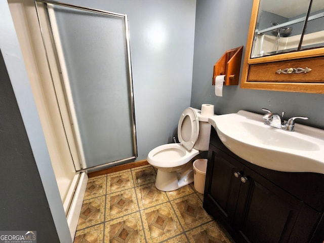 bathroom featuring an enclosed shower, vanity, and toilet