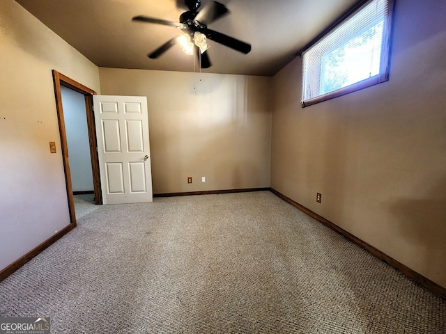 unfurnished room with carpet flooring and ceiling fan