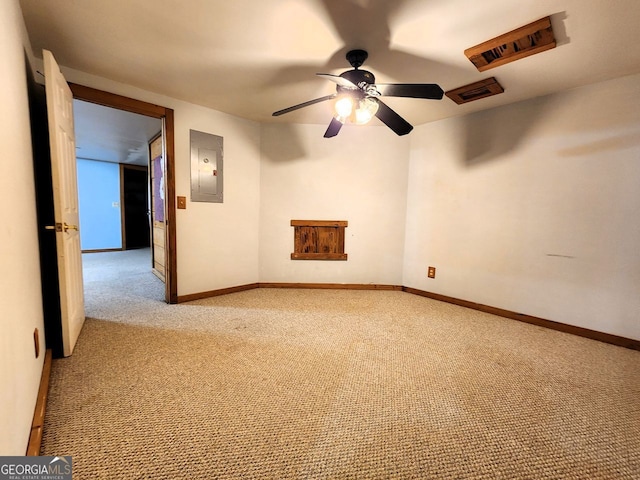 carpeted empty room featuring electric panel and ceiling fan