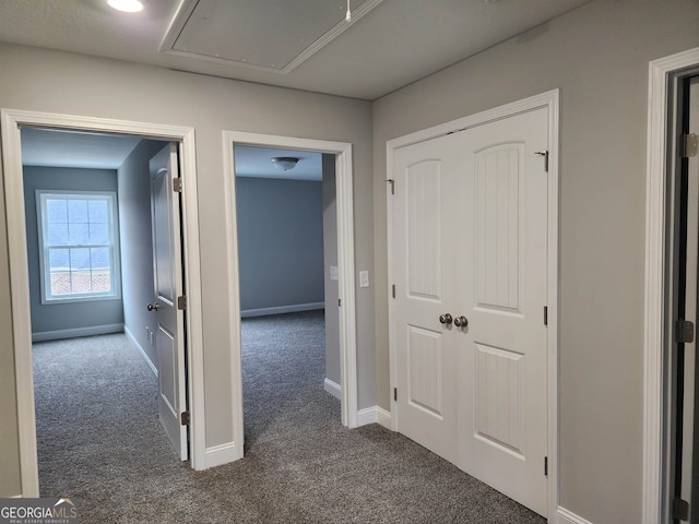 corridor with dark colored carpet