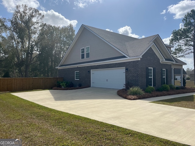 view of side of home featuring a yard and a garage