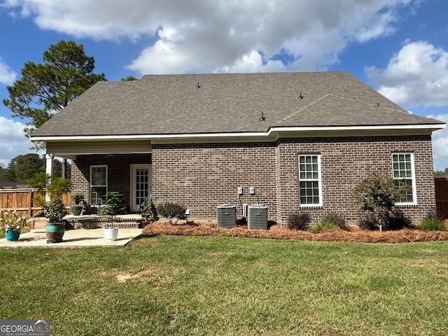 back of property featuring a patio area and a lawn