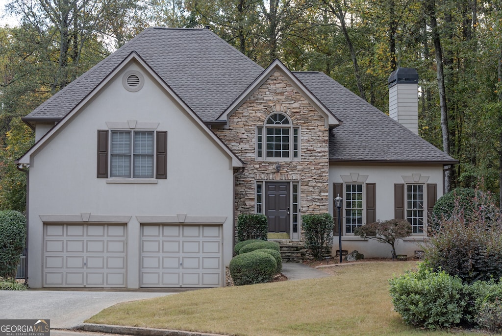 view of front of property with a front lawn and a garage