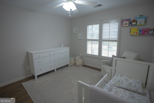 bedroom featuring dark hardwood / wood-style flooring and ceiling fan