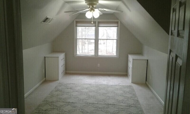 additional living space featuring ceiling fan, lofted ceiling, and light carpet